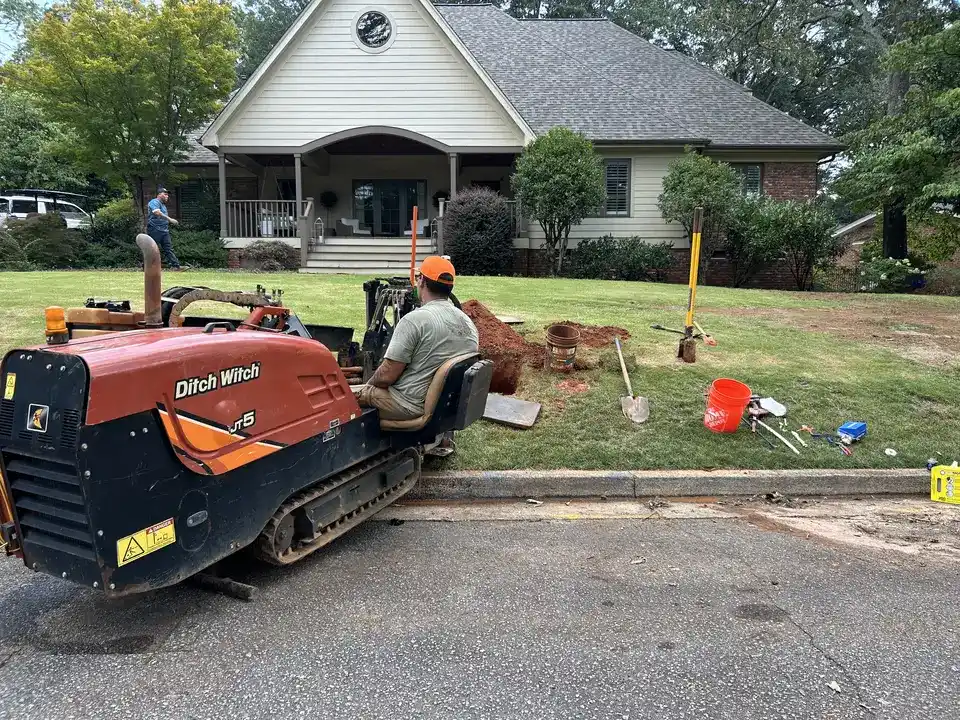 Ditch Witch directional drill boring a new utility line beneath the front yard of a Greenville, SC home