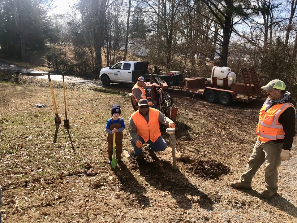 Sloan Underground crew boring a water service line down a steep Upstate SC lakefront lot toward a boat dock